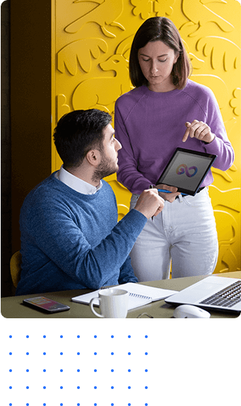 Illustrative collaborators reviewing digital work