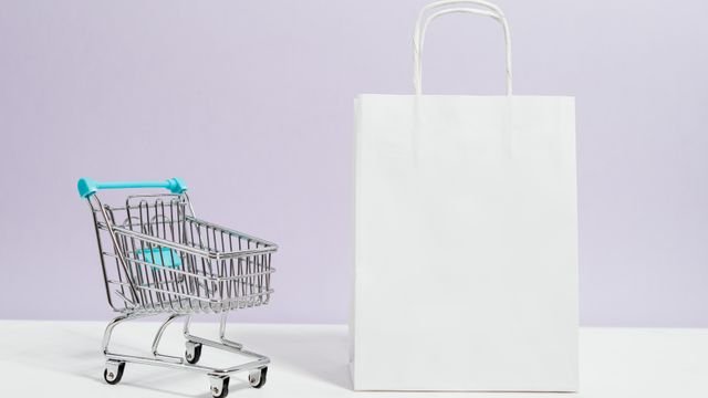 Shopping trolley beside a paper shopping bag