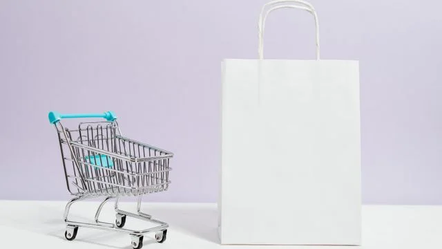 Shopping trolley beside a paper shopping bag
