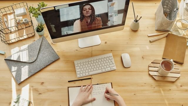 Online lesson on a desktop computer with study notes