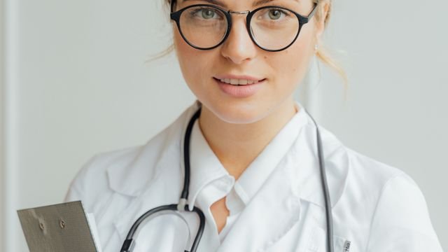 Healthcare professional wearing glasses and a stethoscope