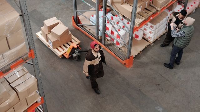 Warehouse staff organizing goods and deliveries