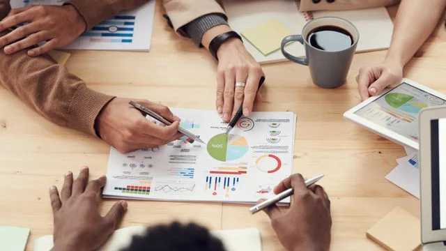 Business collaborators reviewing charts at a table